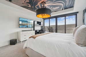 Carpeted bedroom featuring access to exterior and baseboards