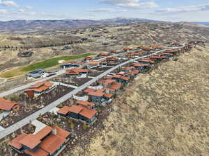 Aerial perspective of suburban area featuring mountains and a local golf course