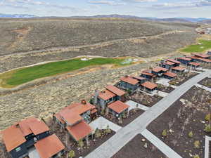 Aerial view of residential area featuring a golf course and mountains