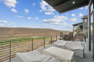 Balcony with outdoor dining area and a mountain view
