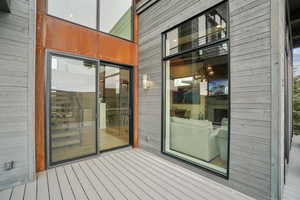 Property entrance featuring a wooden deck