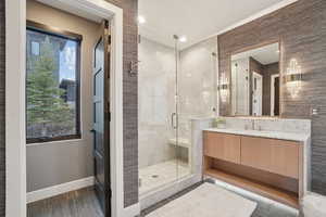 Full bath with vanity and a shower stall