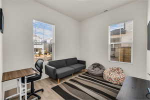 Office space featuring light wood finished floors and healthy amount of natural light