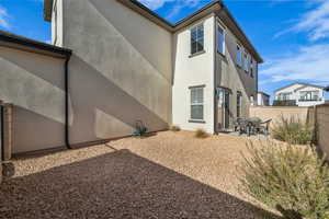 Back of house with stucco siding, a patio area, and a fenced backyard