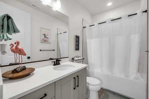 Full bathroom featuring vanity, shower / bath combo, and light wood-style flooring