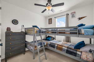 Bedroom featuring light colored carpet and a ceiling fan