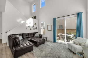 Living room featuring a towering ceiling and stairs