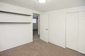 Unfurnished bedroom with carpet floors and a closet