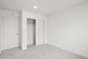 **DISCLAIMER** Interior colors & finishes may vary.Unfurnished bedroom with light colored carpet, a closet, and recessed lighting