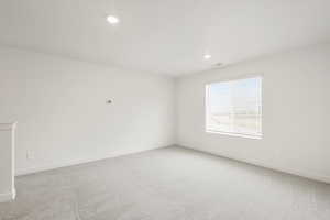 **DISCLAIMER** Interior colors & finishes may vary.Empty room featuring light carpet and recessed lighting
