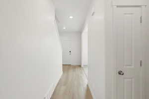 **DISCLAIMER** Interior colors & finishes may vary.Hall featuring light wood-type flooring and recessed lighting