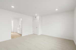 **DISCLAIMER** Interior colors & finishes may vary.Spare room with light carpet and recessed lighting