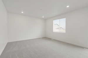 **DISCLAIMER** Interior colors & finishes may vary.Unfurnished room with light carpet and recessed lighting