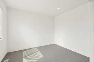 **DISCLAIMER** Interior colors & finishes may vary.Unfurnished room featuring carpet and recessed lighting