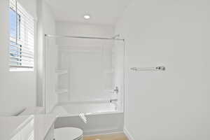 Full bath featuring vanity,  shower combination, and light wood-type flooring