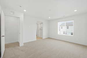 Unfurnished bedroom featuring light colored carpet and recessed lighting