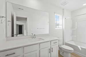 Full bathroom featuring vanity, tub / shower combination, and light wood-style flooring