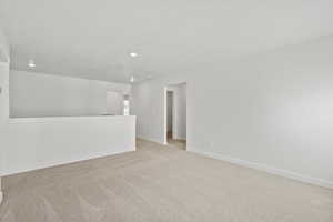 Spare room with light colored carpet and recessed lighting