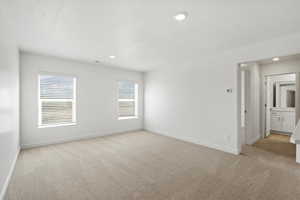 Spare room with light colored carpet and recessed lighting