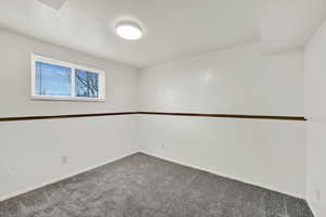 Carpeted empty room with baseboards