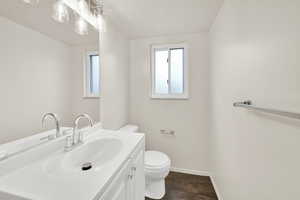 Bathroom with vanity and dark wood-type flooring