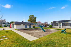 Surrounding community with a playground and a yard