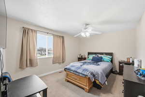 Bedroom featuring light colored carpet and ceiling fan