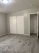 Unfurnished bedroom featuring multiple closets and carpet