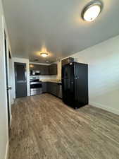 Kitchen with stainless steel appliances, light countertops, and dark wood finished floors