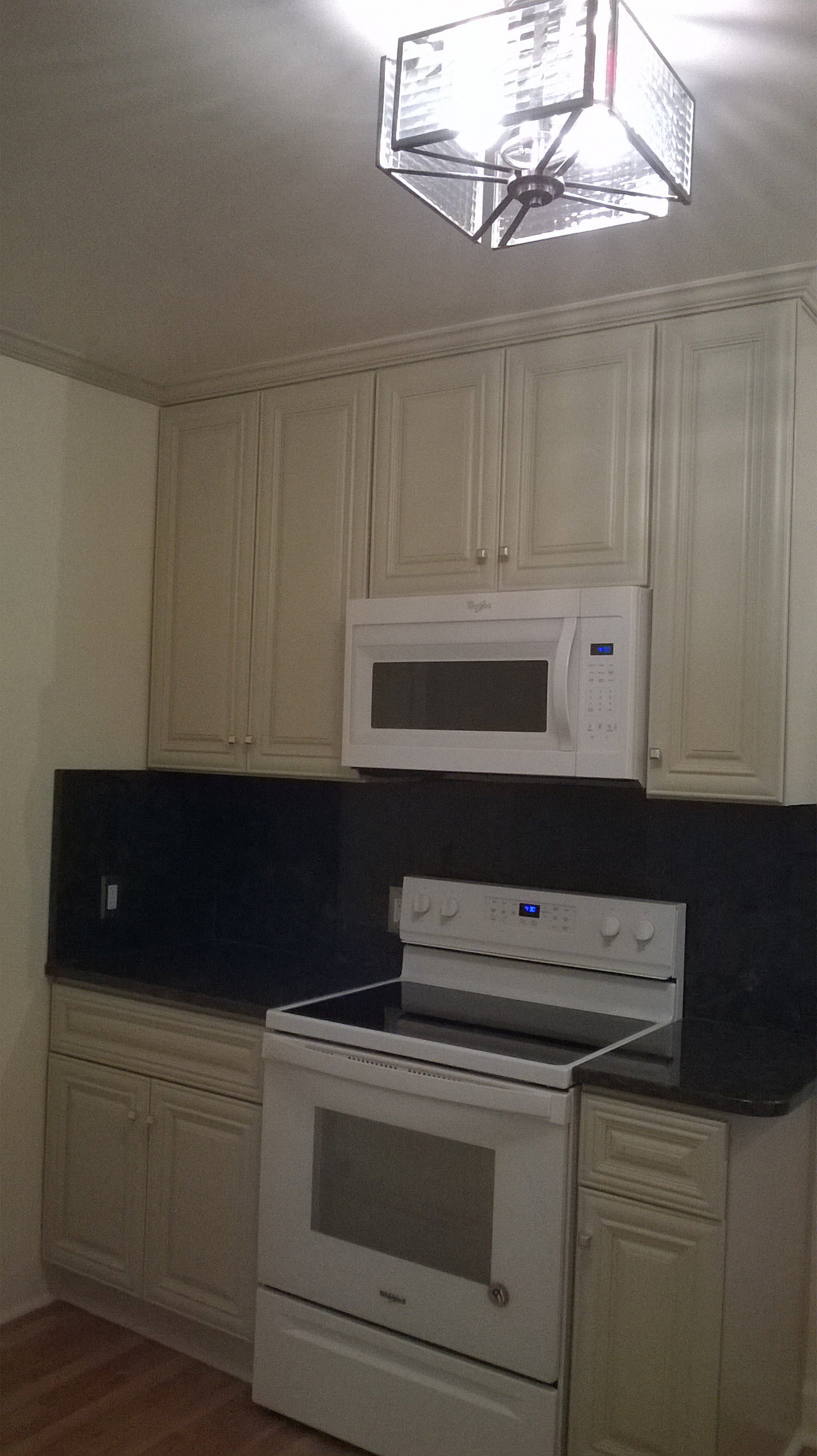 Apt # 1 Kitchen featuring white appliances and dark wood-style floors