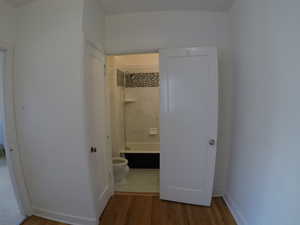 Apt # 8 > Hallway with light wood-style flooring and baseboards