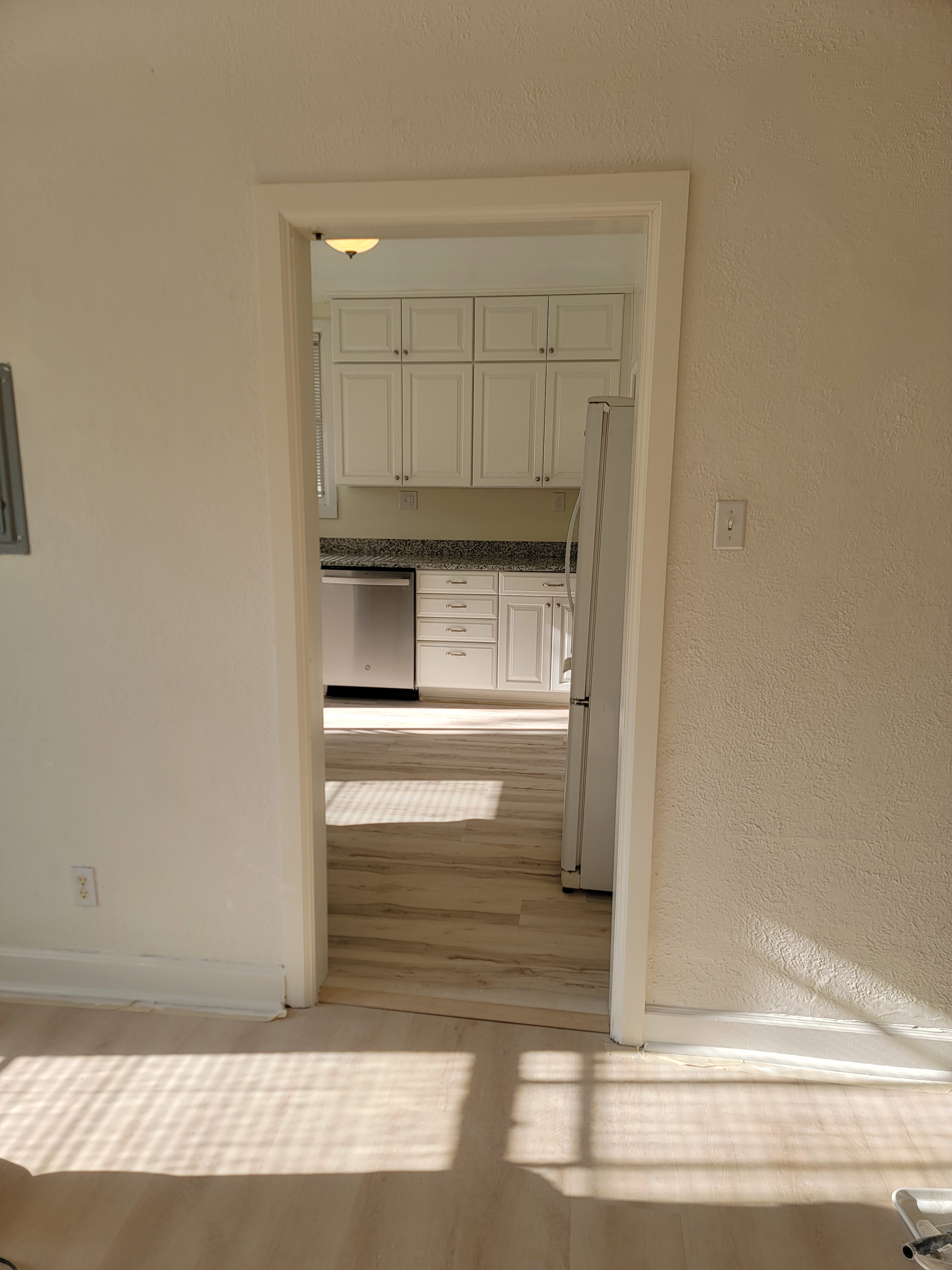 Apt # 9 > Hallway with a textured wall and light wood-style floors