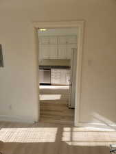 Apt # 9 > Hallway with a textured wall and light wood-style floors
