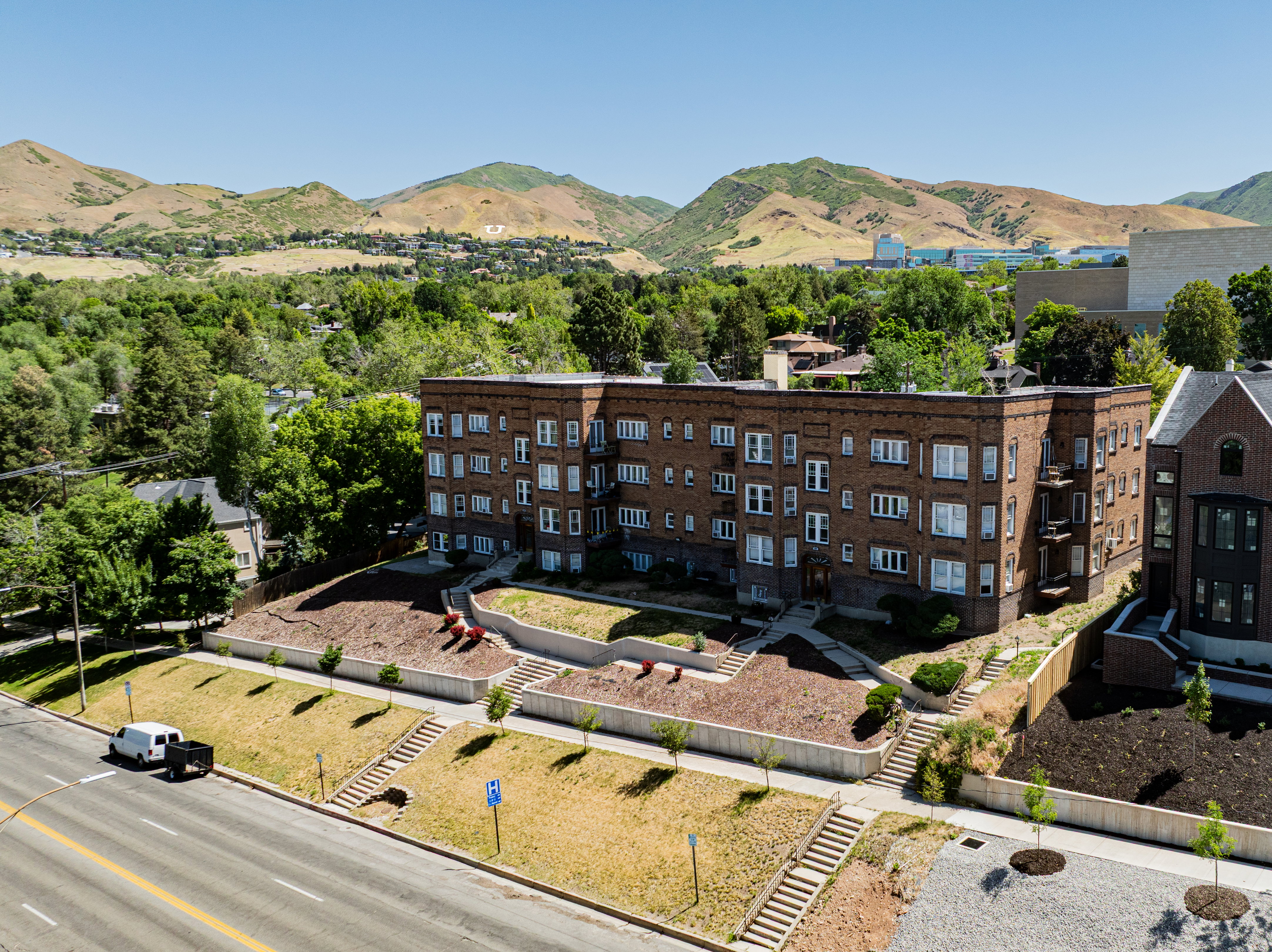 Brick exterior apartment building featuring multiple levels and window configurations