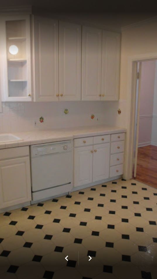 Apt # 5 > Kitchen featuring white dishwasher, white cabinetry, light countertops, and light floors