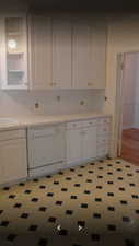 Apt # 5 > Kitchen featuring white dishwasher, white cabinetry, light countertops, and light floors