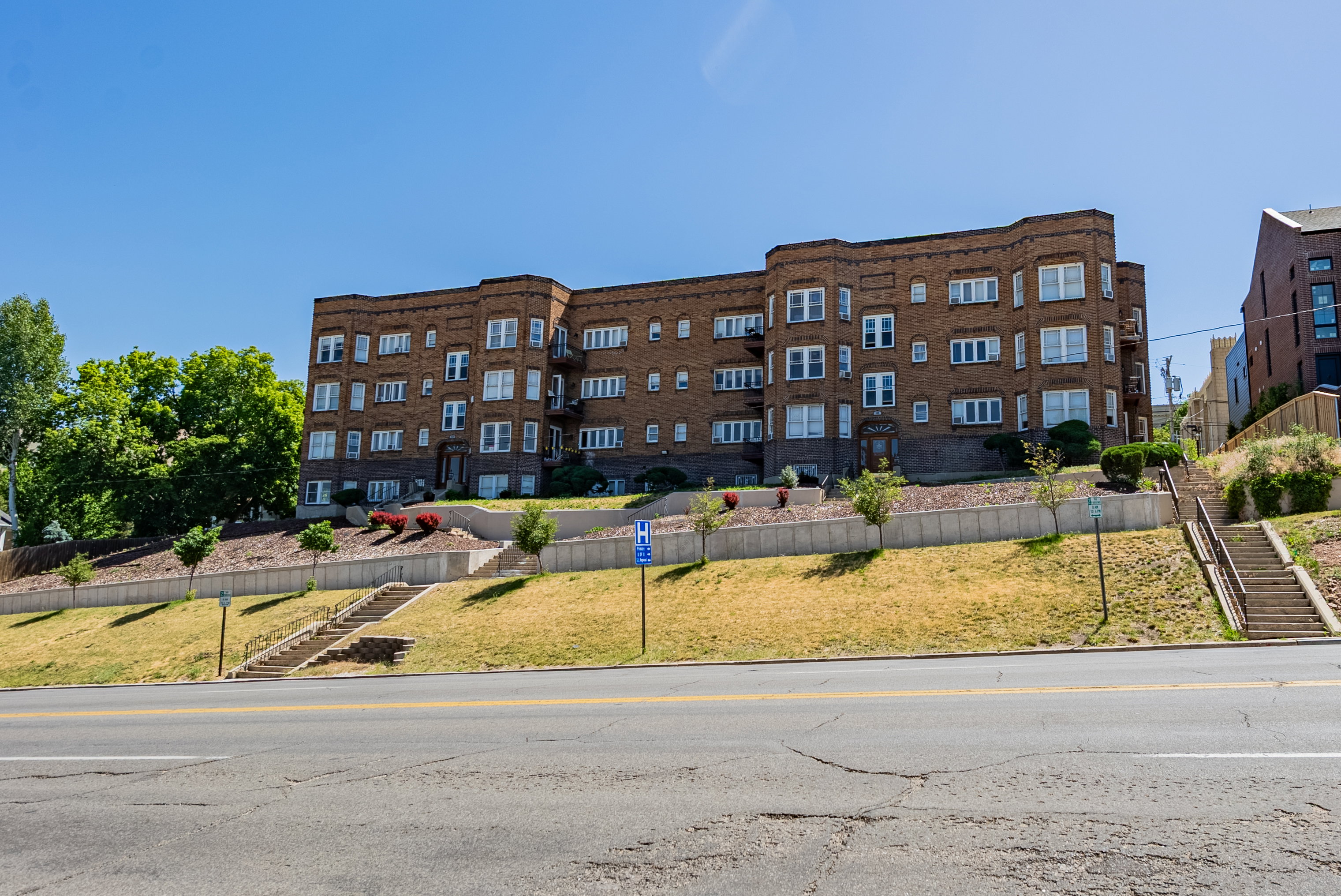Brick multi-story building featuring multiple bay windows and balconies