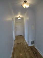 Apt # 15 > Hall with light wood-style flooring and baseboards