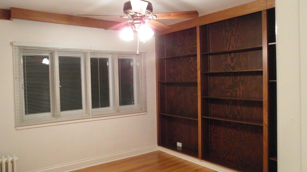 Apt # 7 > Spare room featuring light wood-type flooring, a ceiling fan, and radiator heating unit