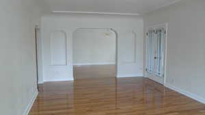 Apt # 10 > Spare room featuring a chandelier and light wood-style floors