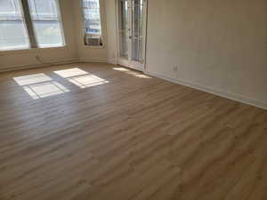 Apt # 9 >  Empty room with wood finished floors and baseboards
