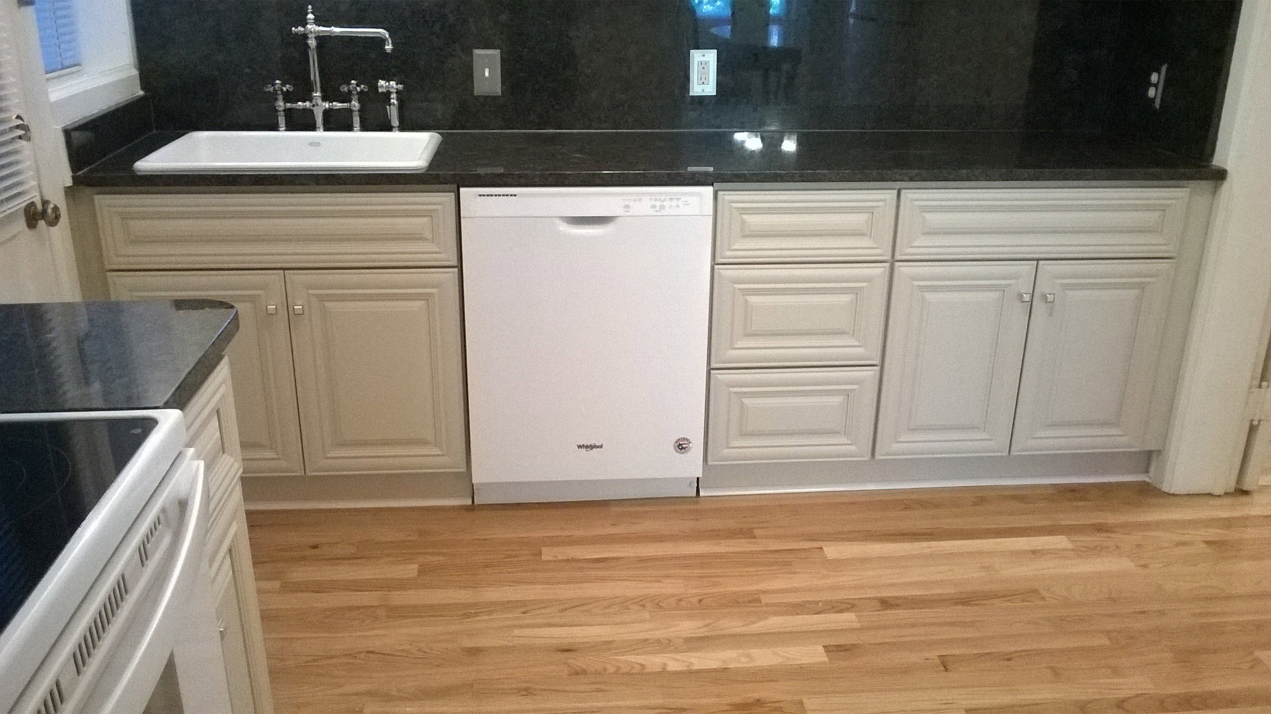 Apt # 1 Kitchen with dark countertops, white appliances, light wood-type flooring, and radiator