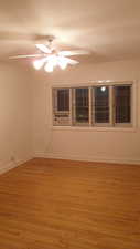 Apt # 12 >Unfurnished room with light wood-type flooring and a ceiling fan