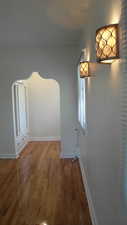 Apt # 10 > Corridor featuring wood finished floors and arched walkways