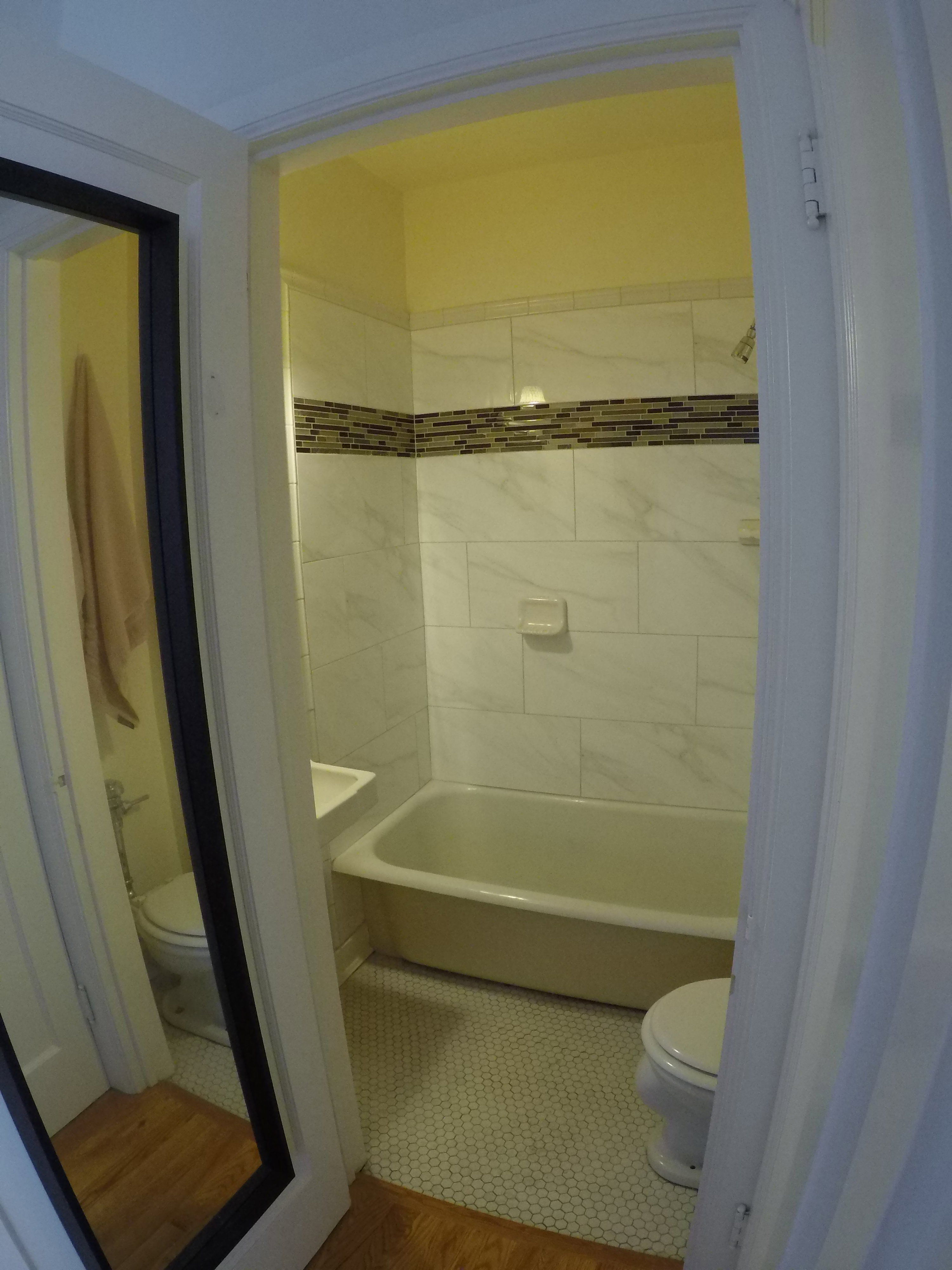 Apt # 7 > Full bathroom featuring toilet and wood finished floors