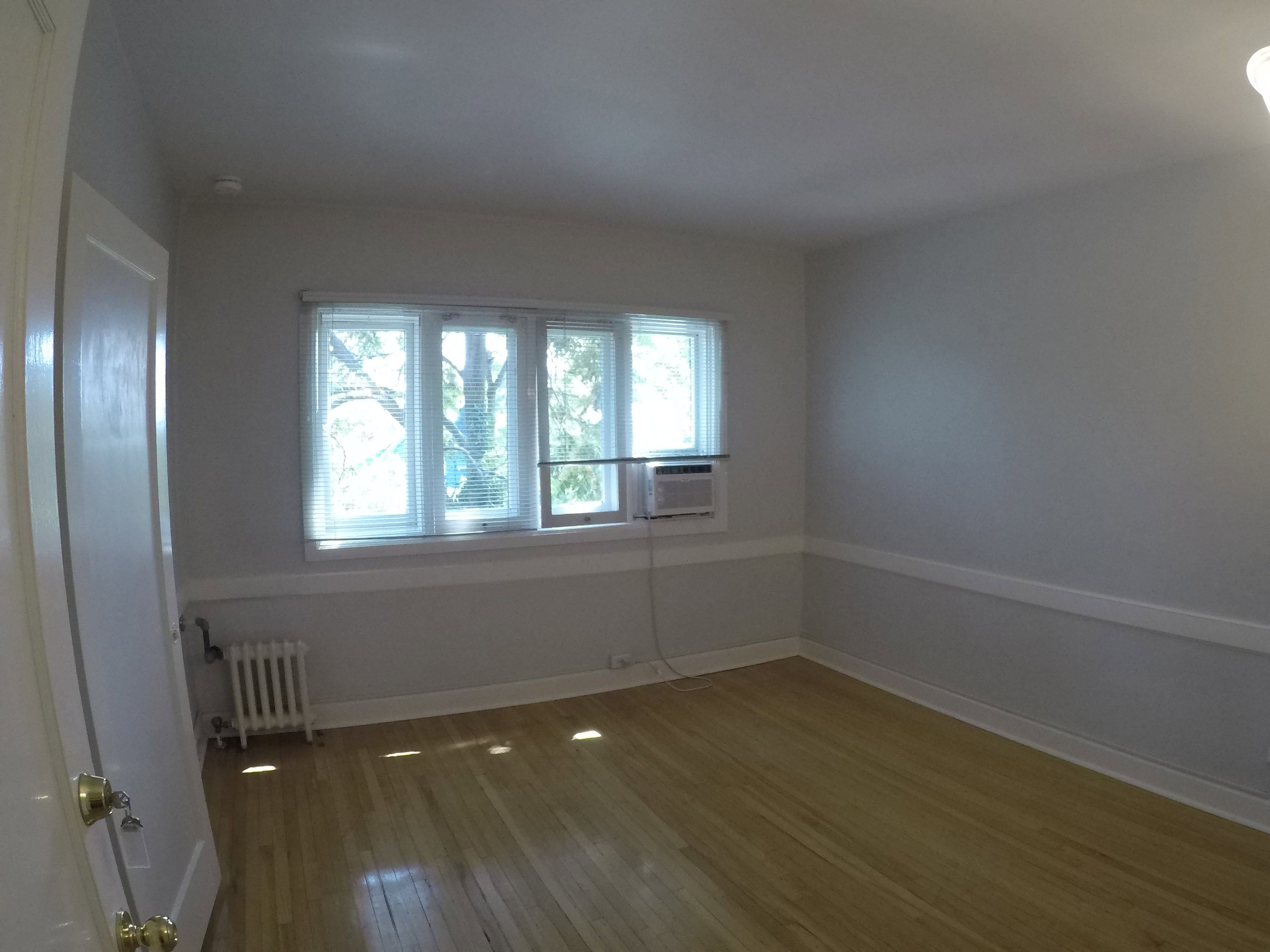 Apt # 15 > Unfurnished room with radiator and light wood finished floors