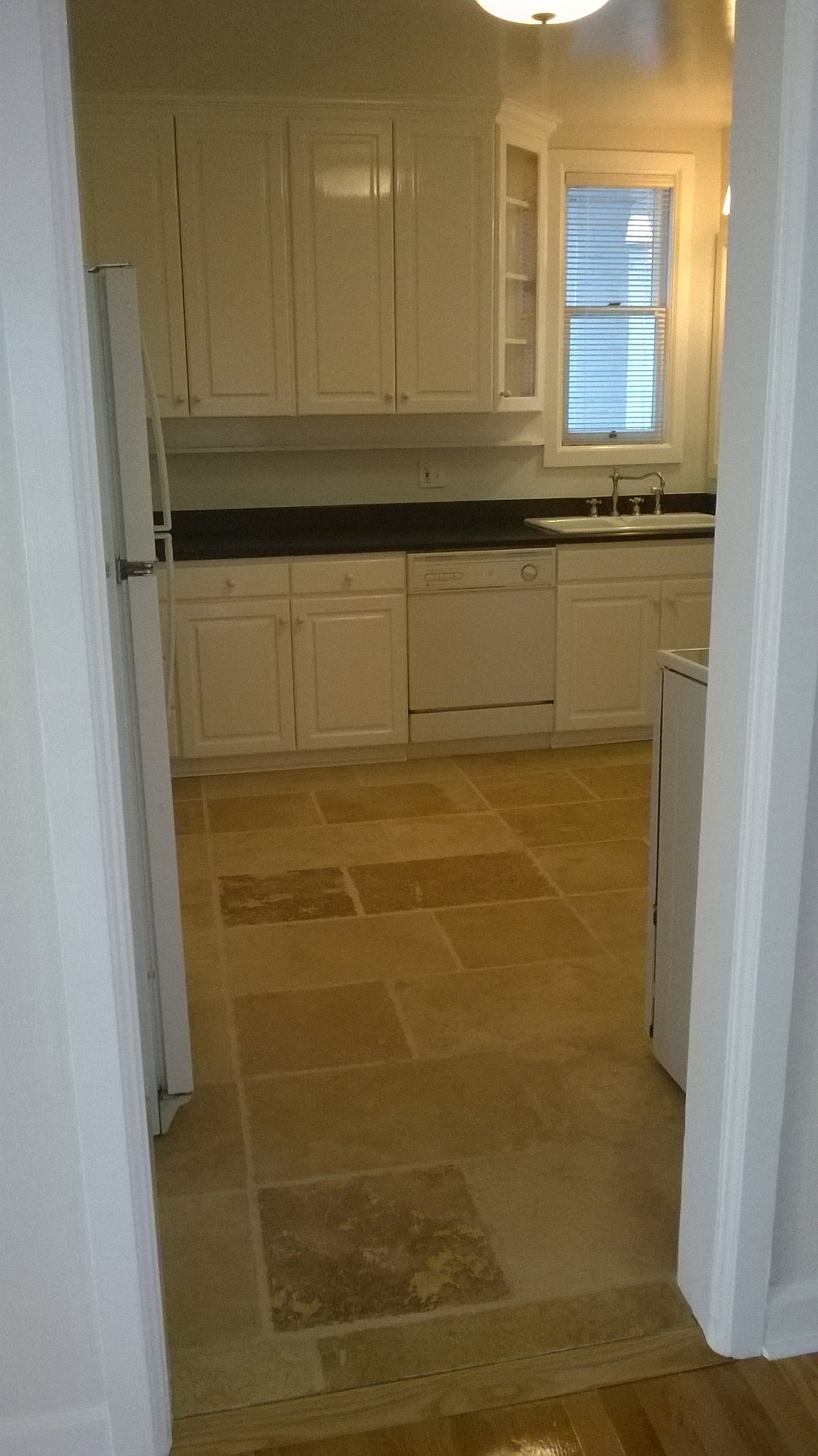 Apt # 10 > Kitchen featuring white cabinetry, dark countertops, white appliances, and glass insert cabinets