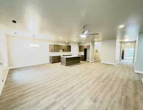 Unfurnished living room with ceiling fan, a chandelier, light wood finished floors, and recessed lighting