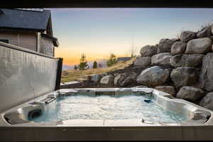 View of pool featuring a hot tub