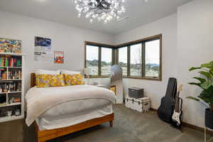 Bedroom with carpet and a chandelier